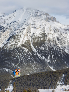 Friends ride the chairlift to the top of the mointain at Mount Norquay.